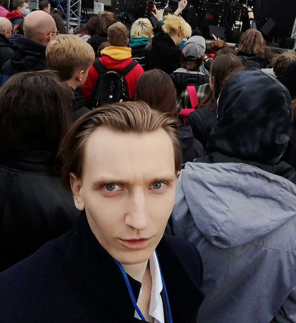 Dmitriy Frostoff. A young person standing behind rock fans